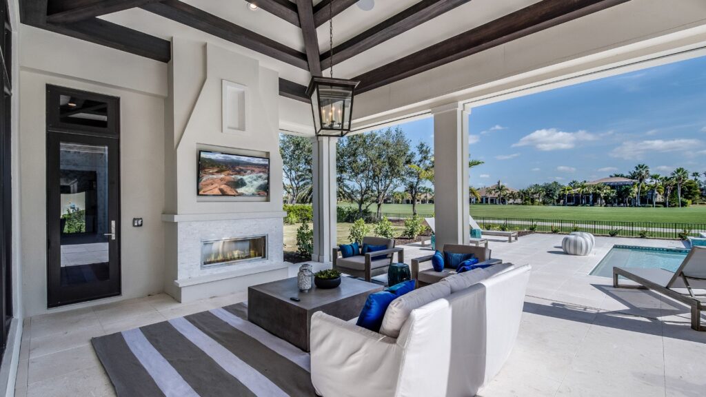 Comfortable outdoor seating arrangement on a porch with cushions and decor